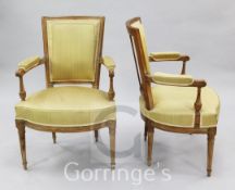 A set of four French Louis XVI style beech framed open armchairs, with angular upholstered backs and