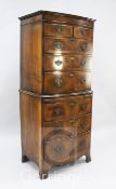 A walnut bowfront chest on chest, with two short and six long drawers and slides, on swept bracket