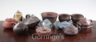 Ten Yixing pottery teapots and covers, two cups and a bowl, 20th century, the teapots of varying