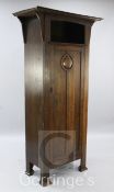 An Arts & Crafts oak hall cupboard, with roundel panelled door, W.3ft 3in.