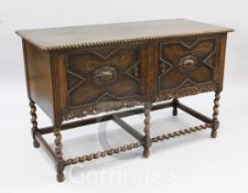 A Jacobean Revival oak side cabinet, with two beaded doors, on barley twist underframe, W.4ft 1in.