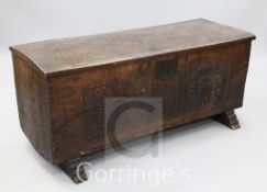 An early 18th century Sussex oak six plank coffer, the front carved with formal rosettes, W.4ft