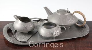 A Liberty English pewter four piece teaset and a similar crumb scoop