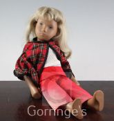 A Sasha doll, wearing tartan cape, 16in.