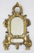 A 19th century Continental carved giltwood wall mirror, with scroll carved frame and triple plate,