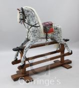 An Edwardian trestle base painted rocking horse, with later dapple grey painted coat, L.4ft 8in.