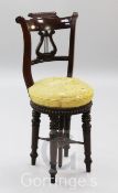 A William IV mahogany harpist's stool, with lyre shaped back and revolving seat, H.2ft 10in.