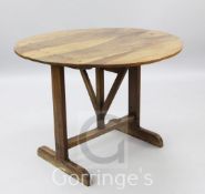 A 19th century French walnut Vignerons table, with folding circular top, W.3ft 2in.