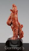 A Chinese coral figure of a beautiful lady holding a basket of flowers, 17.5cm incl. wood stand