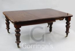 A Victorian mahogany extending dining table, with three extra leaves on stiff leaf turned legs and