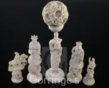 A Chinese export ivory puzzle ball and stand and four similar ivory chess pieces, 19th / early