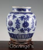 A Chinese blue and white ovoid jar and cover, 19th century, painted with lotus flowers, scrolling