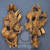 A pair of Black Forest style carved wood wall appliques, with dog's head, game and chamois trophies,