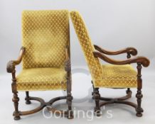 A pair of Flemish style foliate carved oak armchairs, with upholstered backs and seats