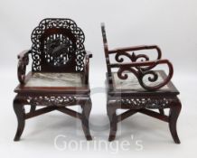 A pair of Chinese hardwood elbow chairs, with dreamstone marble inset seats and kylin carved