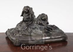 A late 19th / early 20th century patinated bronze group modelled as two spaniels, on a rectangular