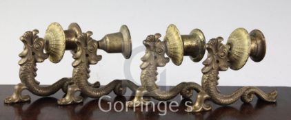 A set of four bronze 'dolphin' wall appliques, each supporting a turned nozzle, 12cm