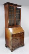 A George III mahogany bureau bookcase, of slender proportions, the later top with two glazed doors