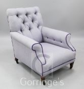 An Edwardian violet tweed upholstered button back armchair, on mahogany square tapering legs and