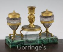 A 19th century French ormolu and cut glass inkstand, with ages of man cast taperstick, now mounted