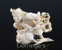 A Japanese ivory okimono of a farmer cutting a large turnip, signed Gyokushi, late 19th / early 20th