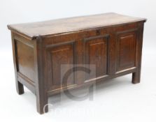 An 18th century oak coffer, with triple panel front, W.4ft 2in.