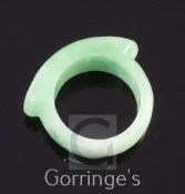 A Chinese jadeite ring, with green inclusions, 3.2cm