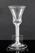 An airtrap stem wine glass, the thistle shaped bowl above a multi-gauze stem on a conical foot, 18.