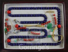 A Chinese lapis lazuli, jadeite and coral necklace, the lapis lazuli beads carved with 'shou'