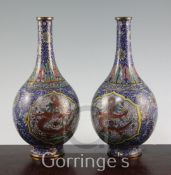 A pair of Chinese cloisonne enamel 'dragon' bottle vases, early 20th century, each decorated in