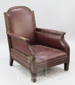 An Edwardian red leather upholstered mahogany framed armchair, with leaf carved arms, on short