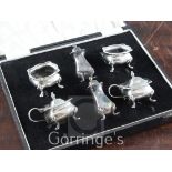 A cased 1930's six piece silver condiment set, on cabriole feet, William Suckling Ltd, Birmingham,