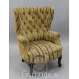 A George I style tub shaped buttoned armchair, on cabriole legs