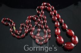 A single strand graduated cherry amberoid necklace, with gilt metal barrel clasp, 46in.