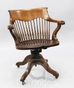 A Victorian mahogany swivel desk chair, with a spindle turned back, raised on four splayed legs with