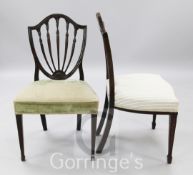 A pair of George III Hepplewhite period shield back chairs, with fluted husk topped spars, over