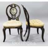 A pair of mid 19th century gilt lacquered mahogany effect boudoir chairs, the pierced balloon shaped