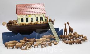 A polychrome painted wooden model of Noah's Ark, width 31in., together with fifty eight carved