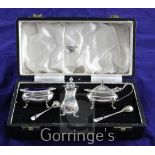 A cased 1960's silver three piece condiment set with two spoons, Cooper Brothers & Sons,