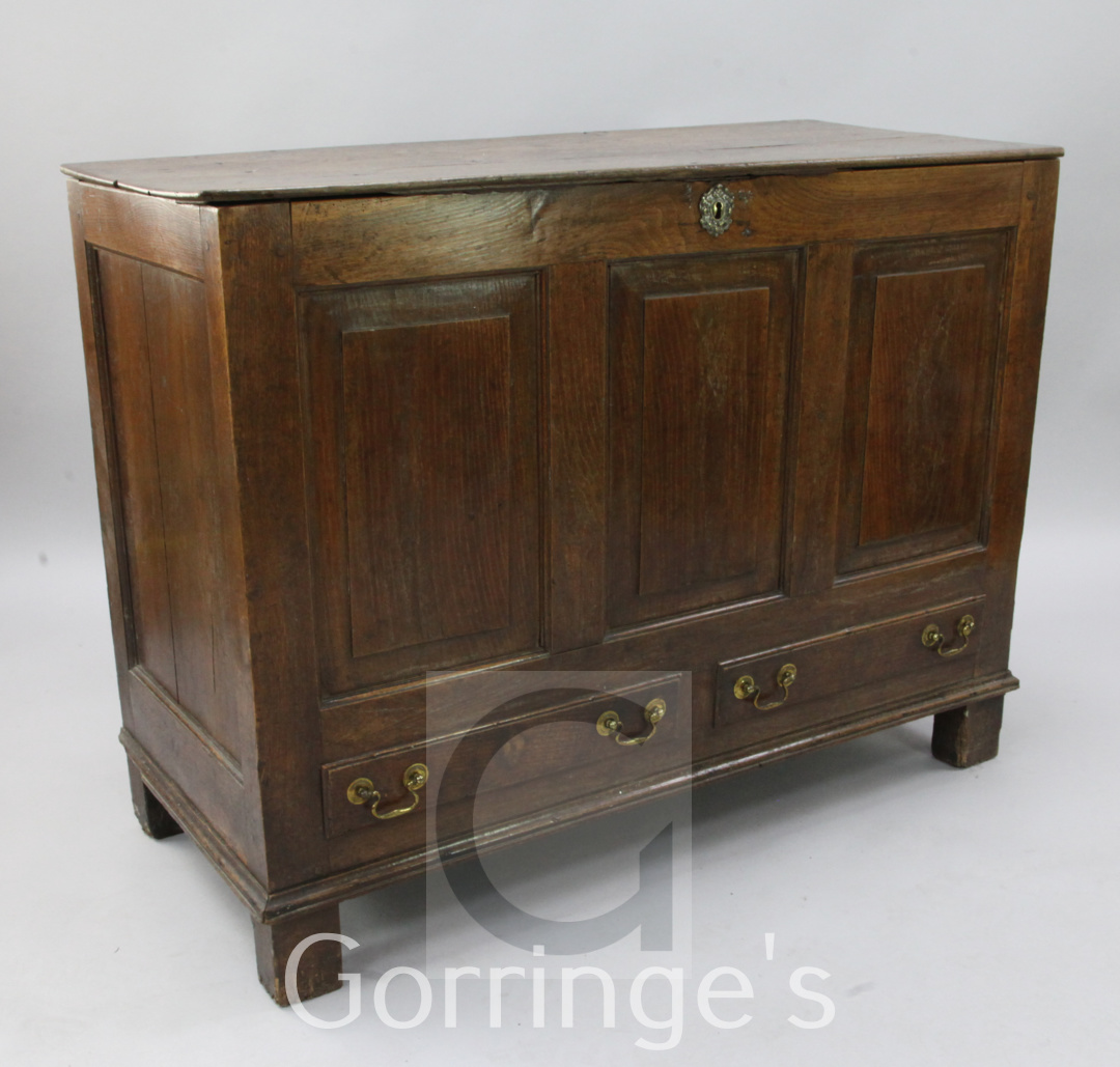 A mid 18th century panelled oak mule chest, with triple fielded panelled front, over two small