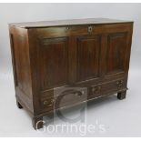 A mid 18th century panelled oak mule chest, with triple fielded panelled front, over two small