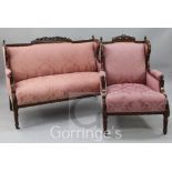 An early 20th century mahogany framed two seat sofa and matching armchair, in neo-classical style,