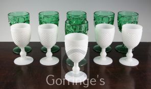 A set of six Victorian green press moulded glass goblets and five similar opaque white glass