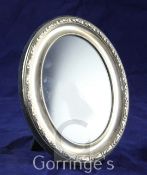 A modern repousse silver oval photograph frame, Carr's of Sheffield, 1988, 6.25in.