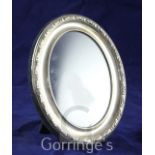 A modern repousse silver oval photograph frame, Carr's of Sheffield, 1988, 6.25in.