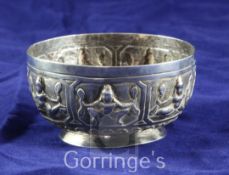 A 20th century Burmese silver bowl, embossed with deities, dia. 4in, 3 oz.