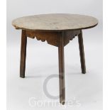 An early 19th century oak circular topped cricket table, on three chamfered supports, diameter 2ft