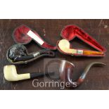 Four Meerschaum and wood pipes, including a female carved cherrywood Nubian head, silver mounted,