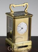 A French gilt brass carriage clock, with white enamel circular dial and gilt mask, early 20th