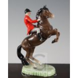 A Beswick pottery group of a huntsman on a rearing horse, model no.868, 14.5cm